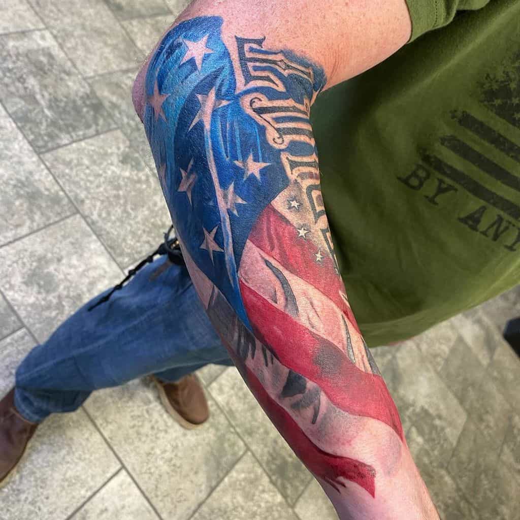 Forearm tattoo of an American flag with an abstract eagle design