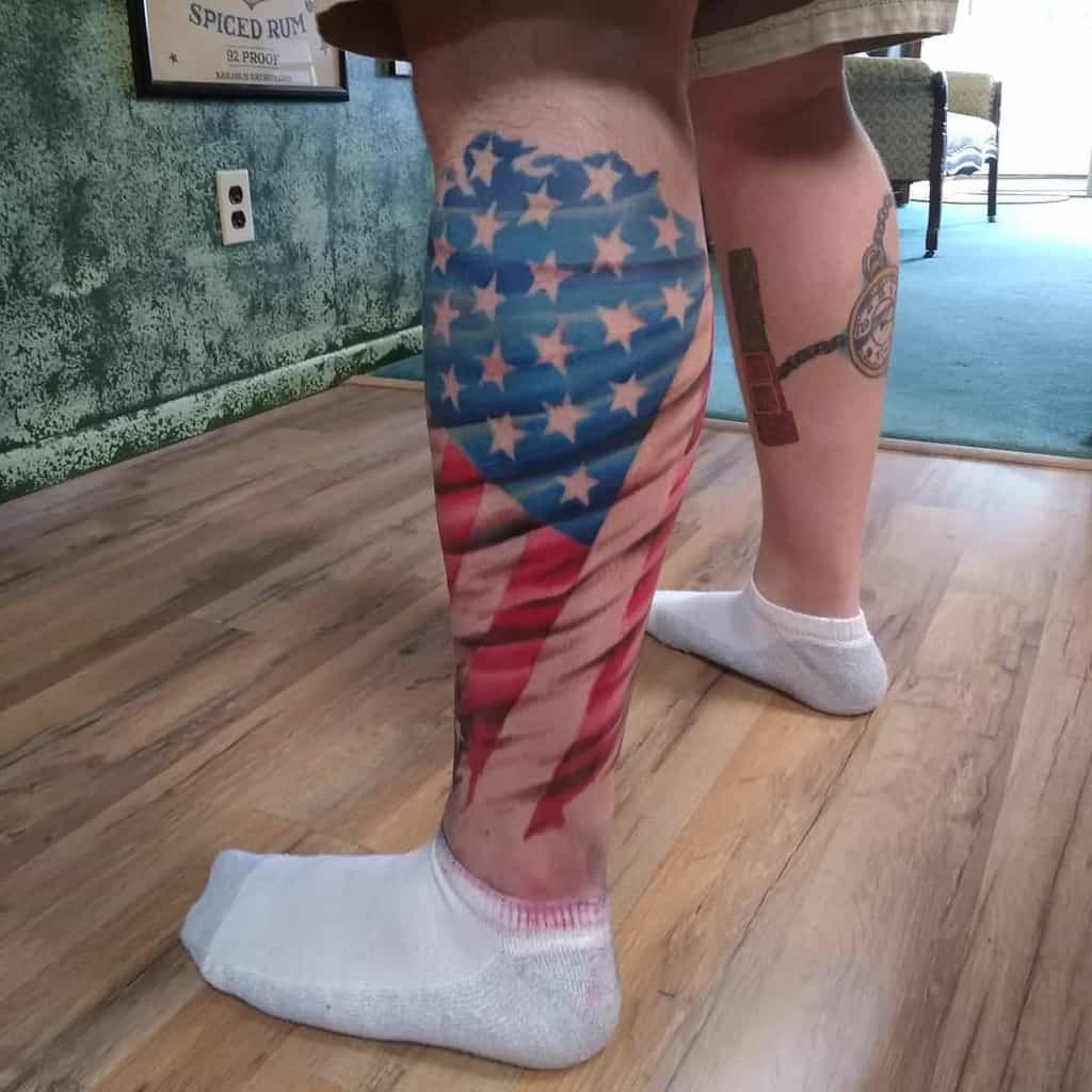 Man's leg with a tattoo of a U.S. flag on the calf