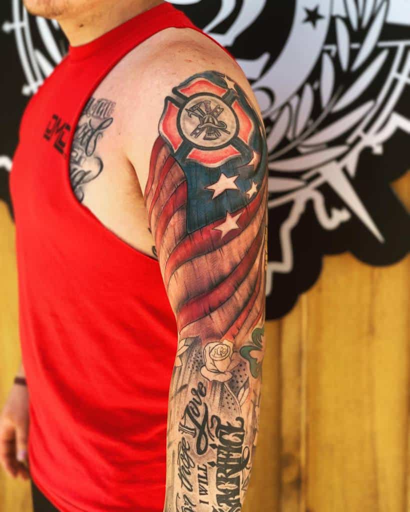 Man with a sleeve tattoo featuring a firefighter emblem and American flag design