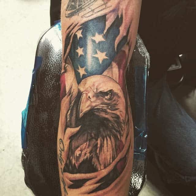 Tattoo of an eagle and American flag on an arm