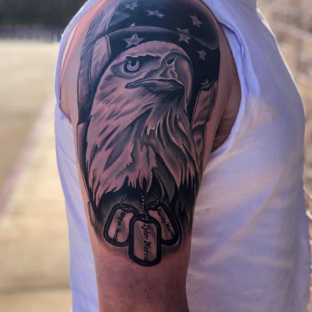 Striking half-sleeve tattoo showcasing a proud bald eagle against an American flag backdrop, complete with dog tags for a personalized and patriotic design