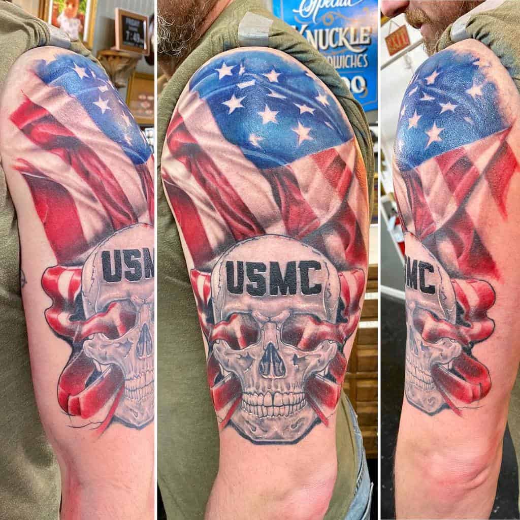 A tattoo featuring a USMC skull and American flag on a man's upper arm