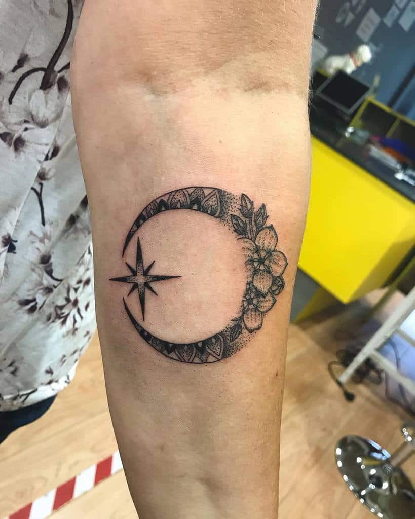 Crescent moon tattoo with flowers and a star