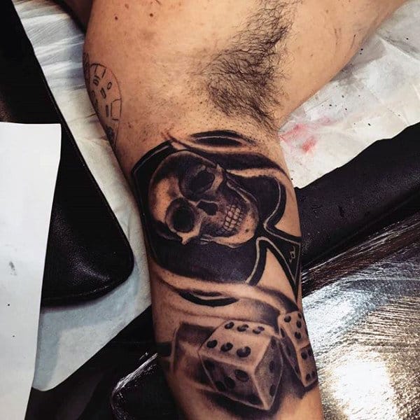 Bicep Mens Skull And Dice Tattoo In Black Ink