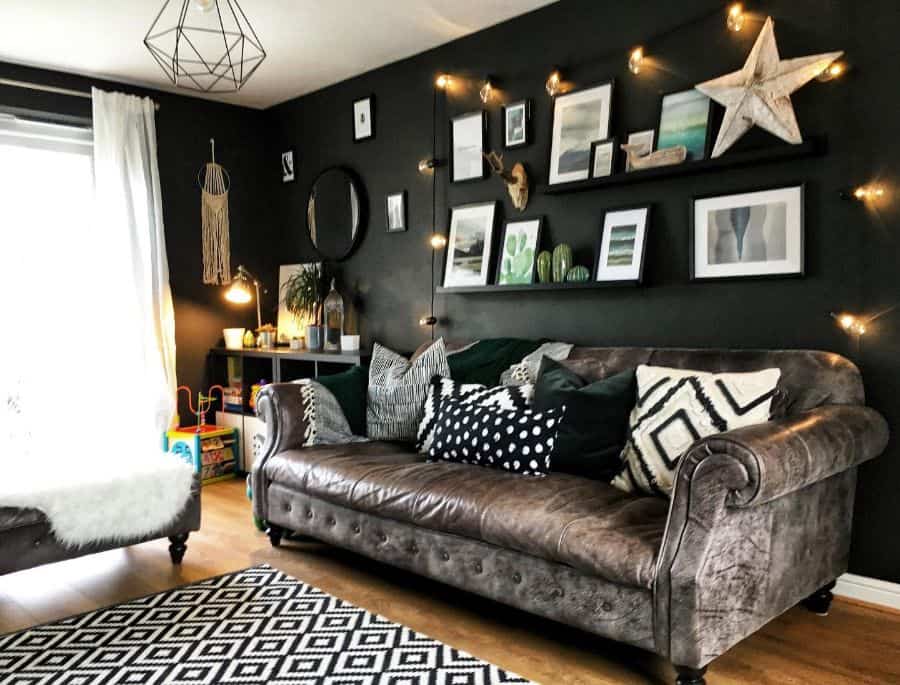 rustic style living room with dark green accent wall and leather sofa 