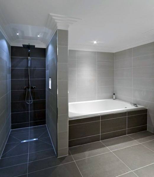 Minimalist bathroom with large tub, walk-in shower, and grey tiled walls and floors.