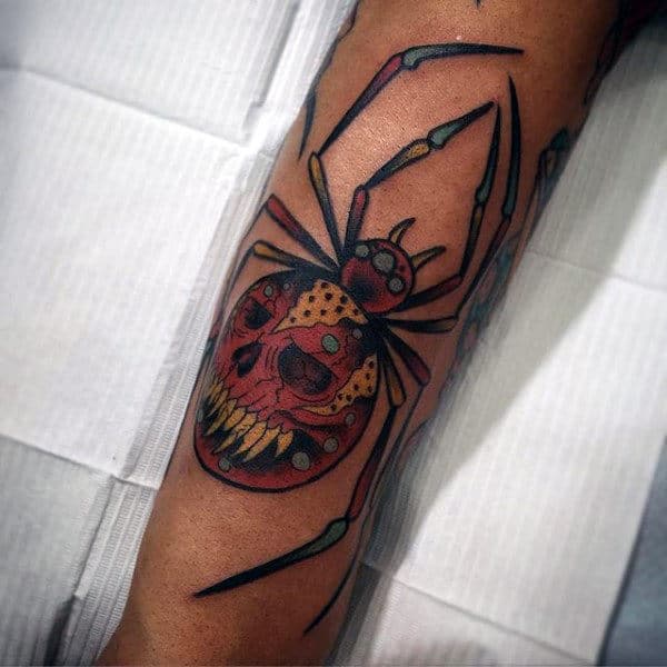 Colorful spider tattoo with a skull face on an arm