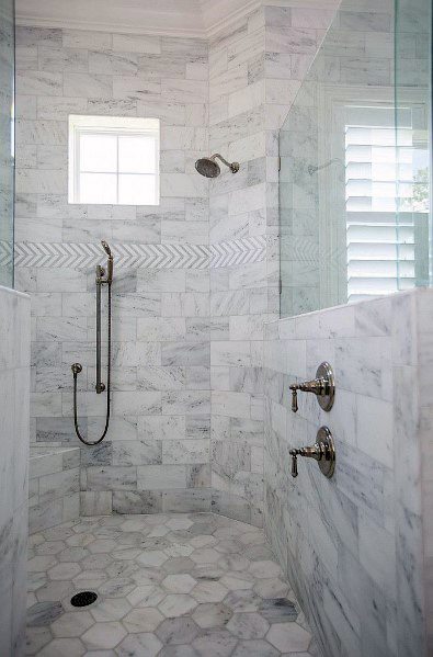 Marble tile shower with intricate floor design and glass enclosure.