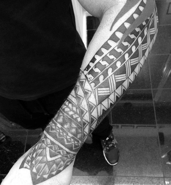 Man With Polynesian Tribal Forearm Tattoos