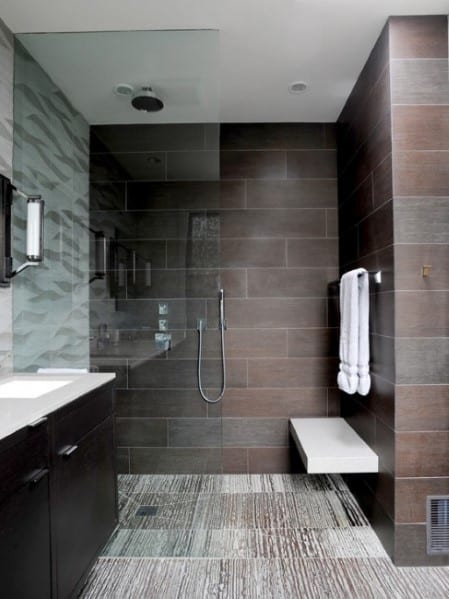 Modern shower with natural stone slate tiles and floating bench.