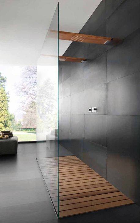 See-through modern shower with wooden floor slats and large glass panel.