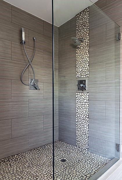 Grey tile shower with pebble feature strip and pebble stone floor.