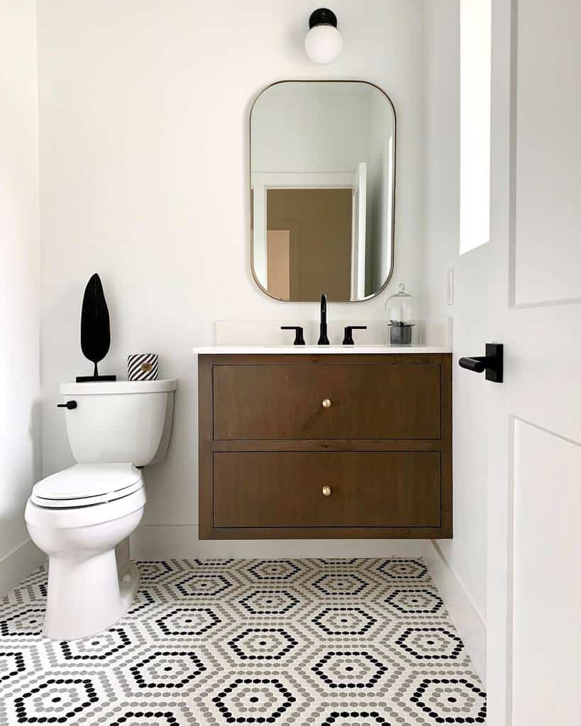 Contemporary bathroom with wooden vanity, hexagonal mosaic floor tiles, and modern decor.