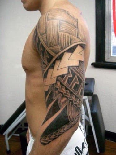 Man with a detailed tribal tattoo covering his upper arm and shoulder