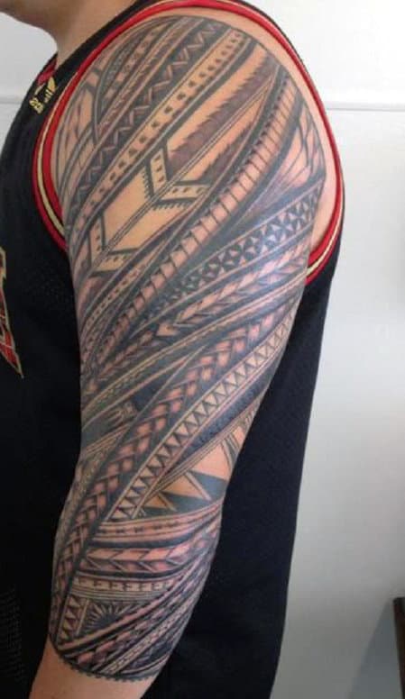 Person with a detailed geometric tattoo sleeve 