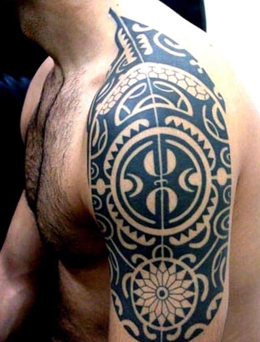 Man with intricate tribal tattoo on his shoulder and upper arm