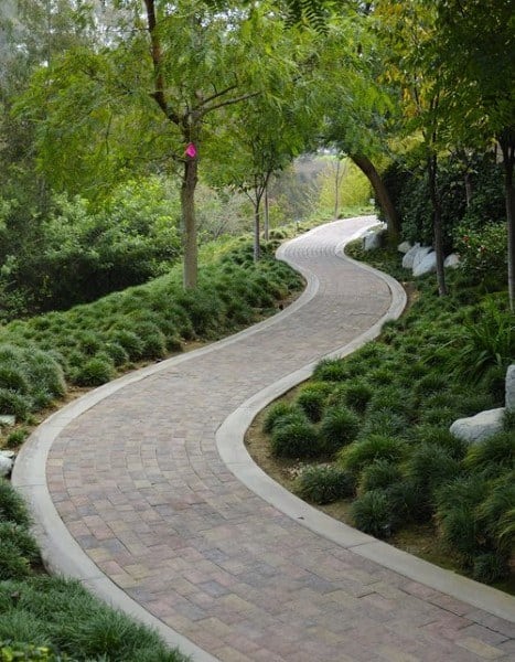 curved brick walkway through park