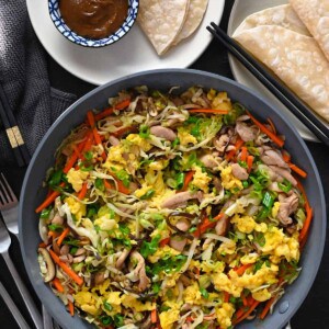 An overhead shot of a big plate of Moo Shu Chicken, with gluten free and Whole30 hoisin sauce and wrappers.