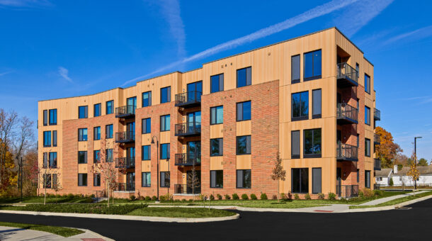 Hamilton at Eagleview Exterior: A modern apartment building featuring a mix of brick and panel exteriors, with large windows and private balconies.