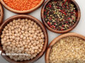 wooden bowls containing legumes and grains