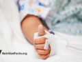 Thumbs up from patient in hospital bed