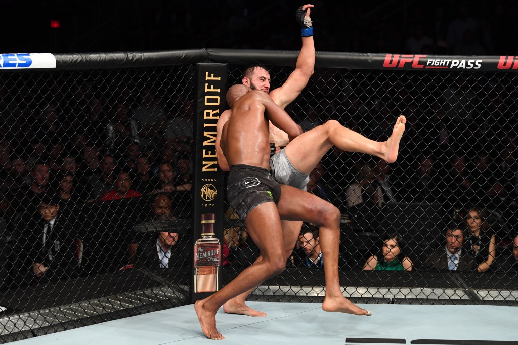 Jon Jones attempts to take down Dominik Reyes during his last fight on Feb. 8, 2020. 