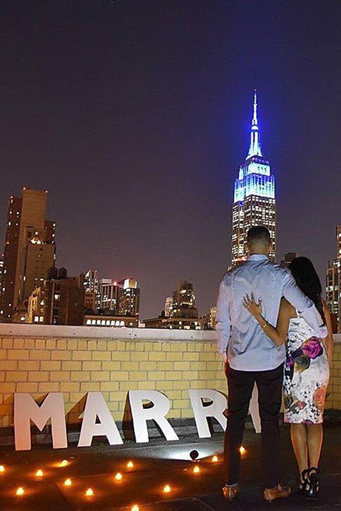 marriage proposal couple roof city engagement