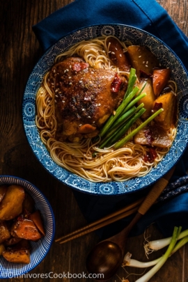 These spicy chicken noodles feature a super rich broth with juicy chicken. Learn to use the steam braising skill to cook a very flavorful chicken in much less time! | omnivorescookbook.com