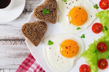 Heart shaped eggs and toast on a plate