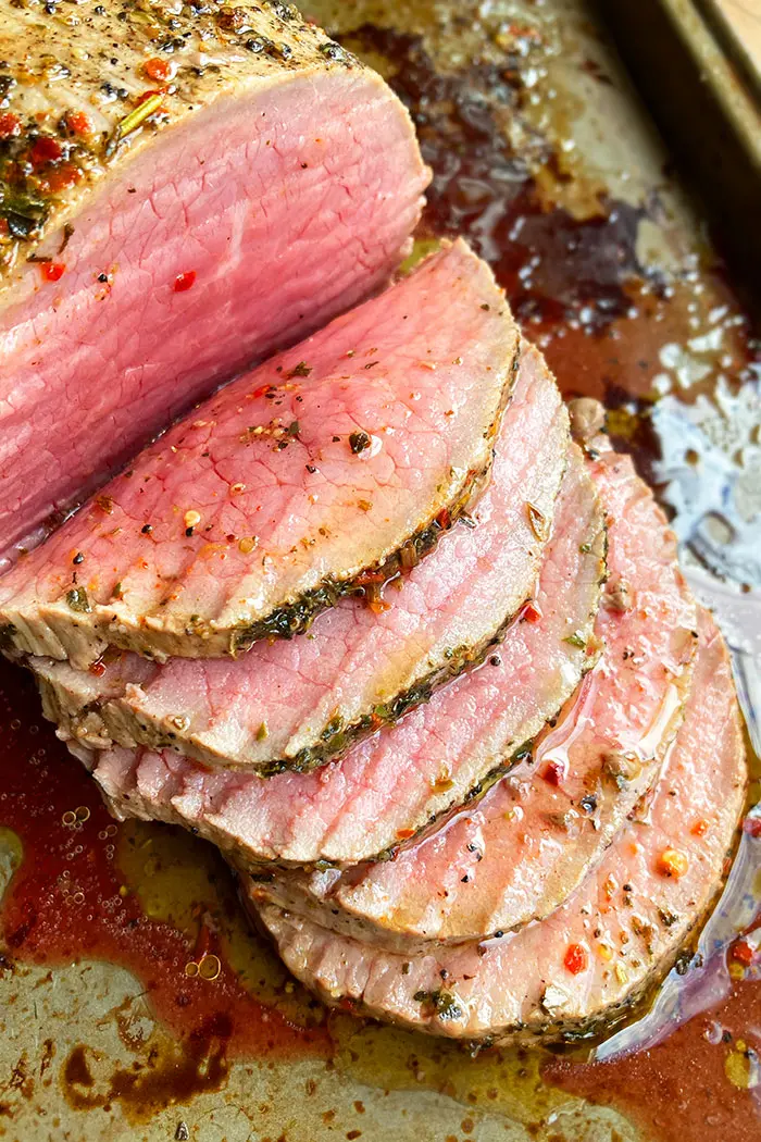 Overhead Shot of Melt in the Mouth Round Bottom Roast Beef with Herbs and Juices