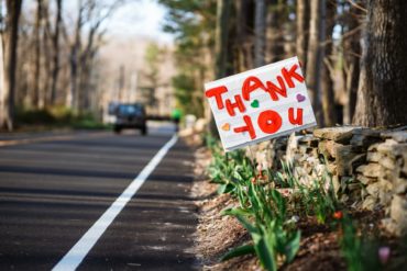 a hand written thank you sign at the side of the road