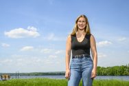 Grace Stank stands in a sunlit field