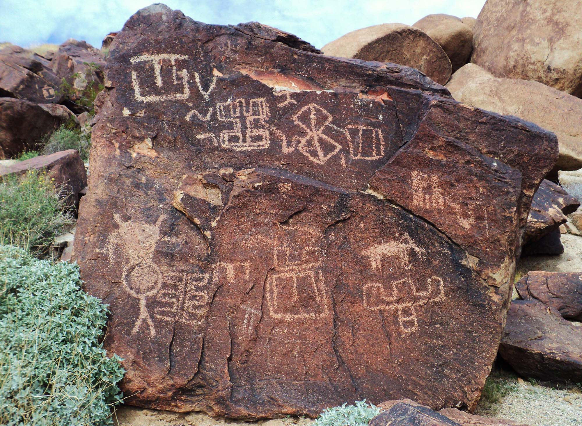 Petroglyphs on a red rock.