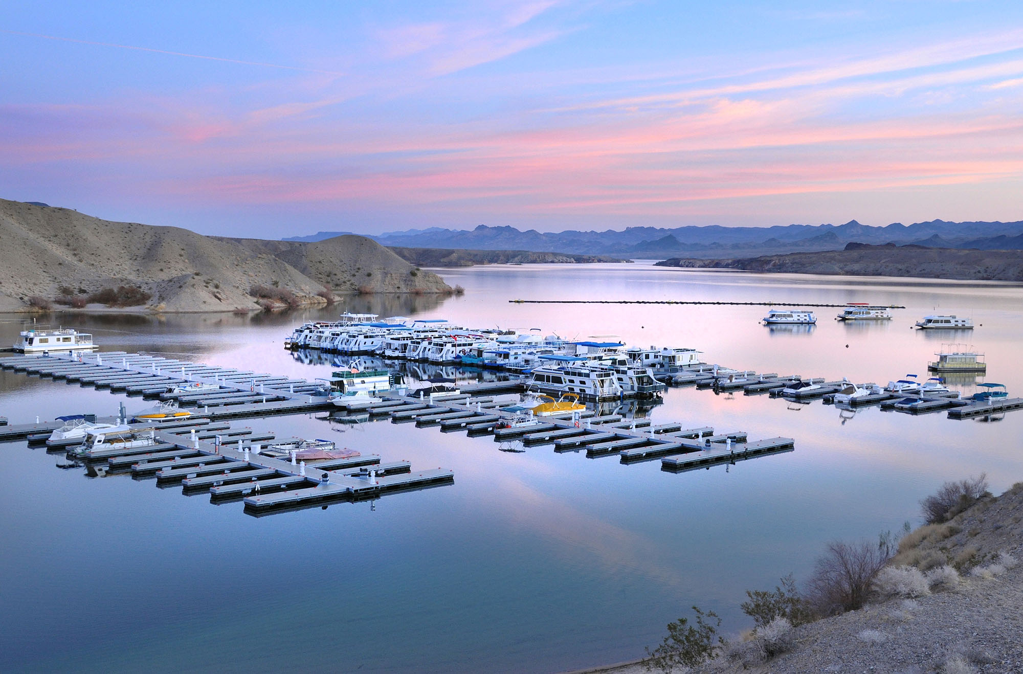 Boats on a lake at dusk.