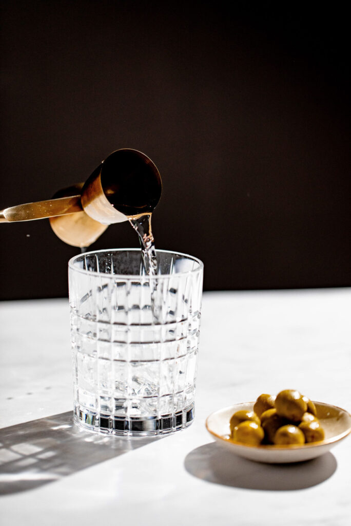 Vermouth being added to a cocktail glass. 