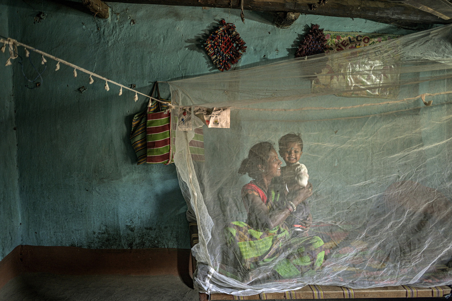 In the village of Bheja, health workers provide members of the community with insecticide-treated nets (ITNs) to prevent malaria and other vector-borne diseases. Sleeping under an insecticide-treated net is one of the most effective ways to prevent malaria. As part of the Chhattisgarh's malaria programme, ITNs are distributed widely by health workers across the state. In recent years, India has made impressive gains in reducing its malaria burden, with cases dropping by more than 40% between 2015 and 2021. Most of the remaining cases are concentrated among tribal populations living in rural areas. This photo set describes efforts by local health workers to reach people at risk of malaria in remote areas of Chhattisgarh, a state that accounts for nearly one fifth of the country’s malaria burden. Related: https://www.who.int/news-room/photo-story/photo-story-detail/reaching-people-at-risk-of-malaria-in-remote-areas-of-Chhattisgarh-india