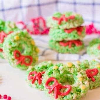 Christmas Rice Krispie Treats with Candy Ribbons against a blue and white background with holiday decorations