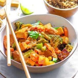 healthy vegetable stir fry recipe served in a white bowl with chopsticks