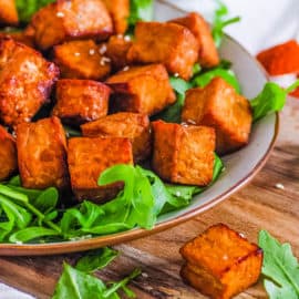 healthy easy vegan air fryer tempeh recipe on a white plate with greens