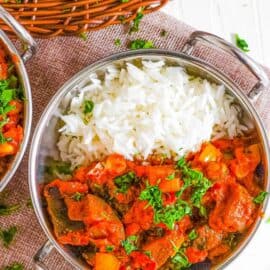 aubergine curry (or brinjal curry / eggplant curry) served with rice in a bowl