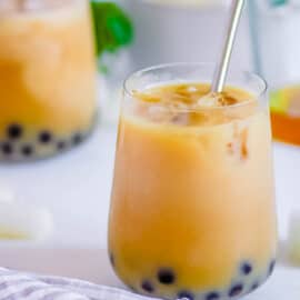 Easy wintermelon milk tea with boba pearls in a glass with a straw.