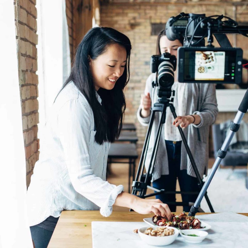 Krista and Alana plating a recipe for a video shoot.