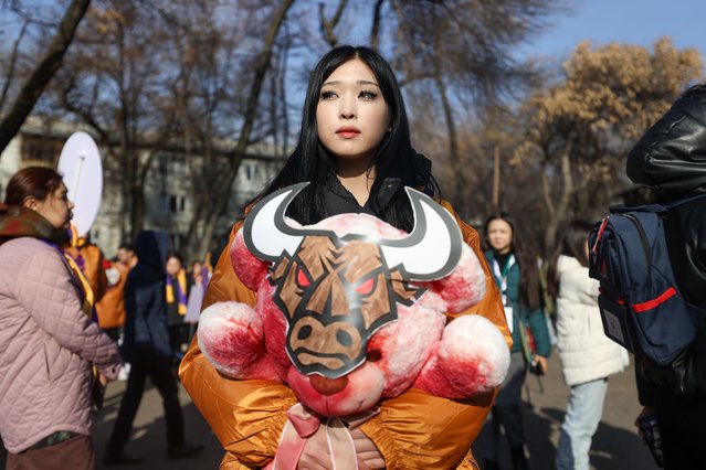 A woman clutches a teddy bear covered in red paint to symbolize blood during a government-approved, anti-violence rally held in the Kazakh city of Almaty on November 26, 2023. Organized by the New People youth movement, roughly 300 people took part. The rally was dubbed “Say No To The Animal World”, with organizers likening violent people to animals. (Photo by Petr Trotsenko/Radio Free Europe/Radio Liberty)