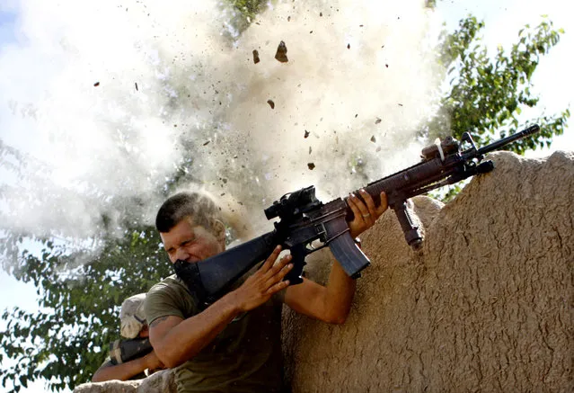 Sgt. William Olas Bee, a U.S. Marine from the 24th Marine Expeditionary Unit, has a close call after Taliban fighters opened fire near Garmsir in Helmand Province of Afghanistan, May 18, 2008. (Photo by Goran Tomasevic/Reuters)