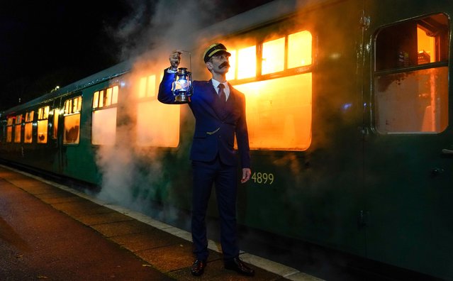 An actor playing the role of the Conductor, poses for a photograph alongside the Polar Express Train Ride at the Swanage Railway in Dorset, UK on Thursday, November 16, 2023, a festive-themed train journey based on the Polar Express book and film, which invites visitors to travel in their pyjamas and dressing gowns as they journey from Swanage to the “North Pole”. (Photo by Andrew Matthews/PA Images via Getty Images)