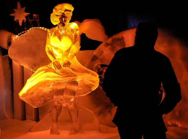 Visitors watch ice-cold artworks, depicting Marilyn Monroe, at an ice and snow sculpture exhibition made by 35 international artists, who worked 4 months at minus eight degrees Celsius in Oberhausen, Germany, on the 1st of Advent, Sunday, December 1, 2024. (Photo by Martin Meissner/AP Photo)