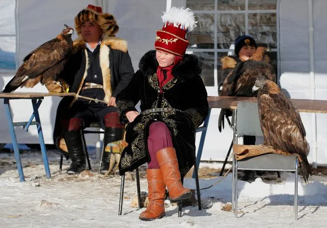 Hunters with their tamed golden eagles take part in a traditional hunting contest outside the village of Kaynar in Almaty region, Kazakhstan on December 8, 2019. (Photo by Pavel Mikheyev/Reuters)