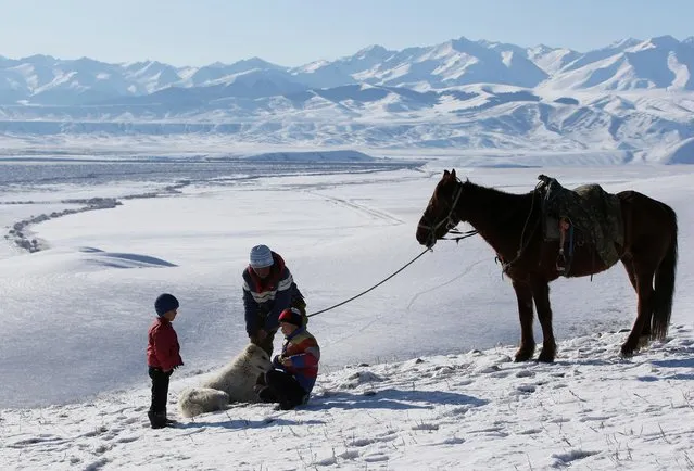 Local residents gather on a slope with a backdrop of the Tien Shan mountains during a traditional hunting contest outside the village of Kaynar in Almaty region, Kazakhstan on December 8, 2019. (Photo by Pavel Mikheyev/Reuters)