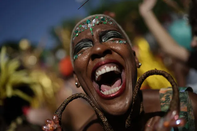 A reveler in costume laughs during the “Cordao do Boitata” street party in Rio de Janeiro, Brazil, Sunday, February 24, 2019, one of the many parades before the official start of Carnival on March 1. (Photo by Leo Correa/AP Photo)