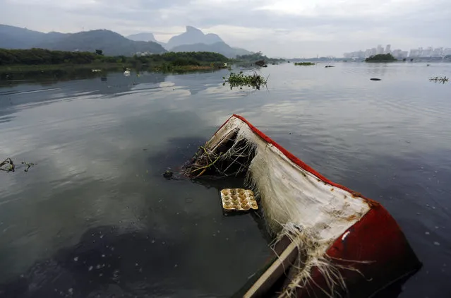 A sofa floats in the polluted waters of Jacarepagua Lagoon, during a press tour in Rio de Janeiro, March 9, 2015. A press tour was organised by biologist Mario Moscatelli, to call attention to pollution on the waters of the lagoons which surround the Rio 2016 Olympic Park. (Photo by Ricardo Moraes/Reuters)